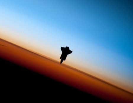 space shuttle over earth