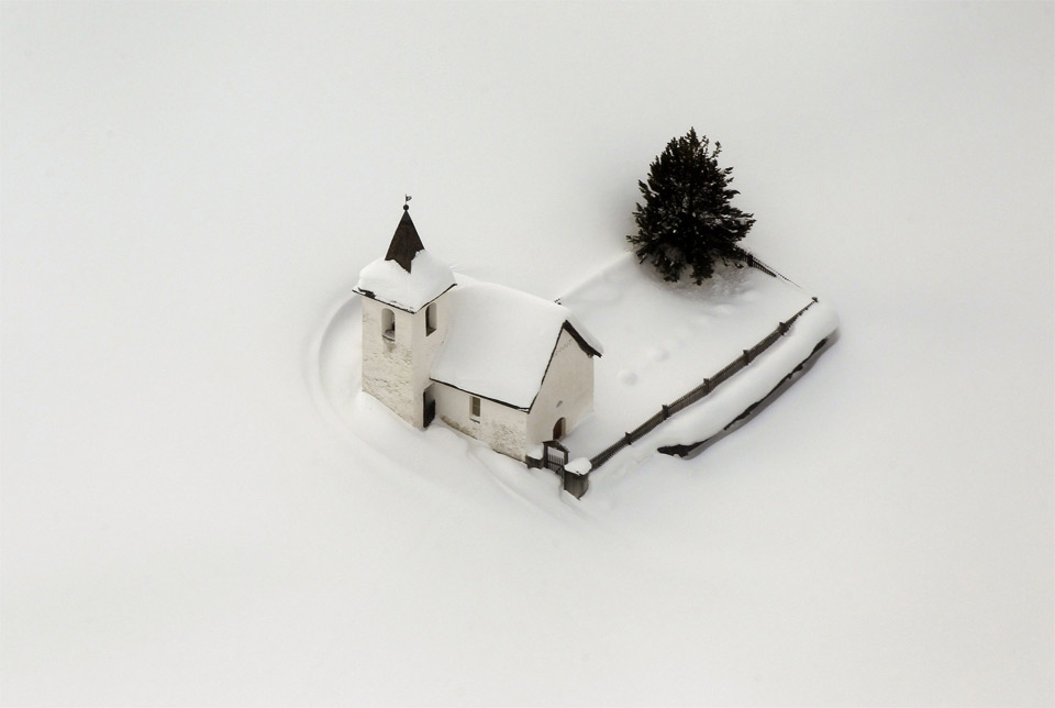 church in switzerland surrounded by snow