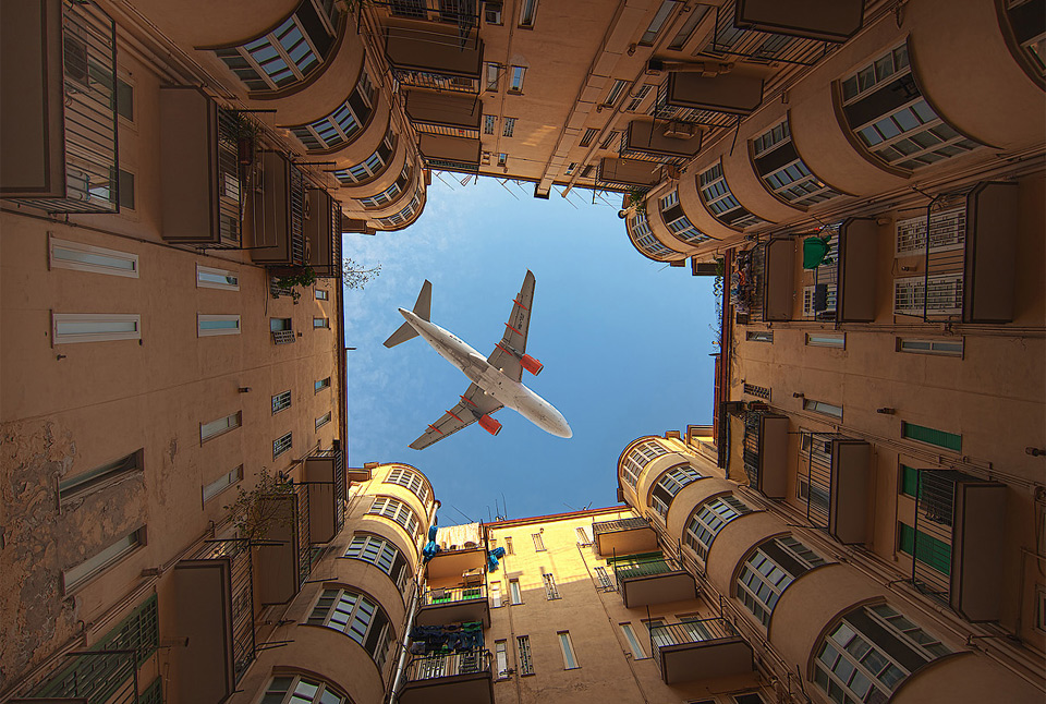 an airplane over buildings