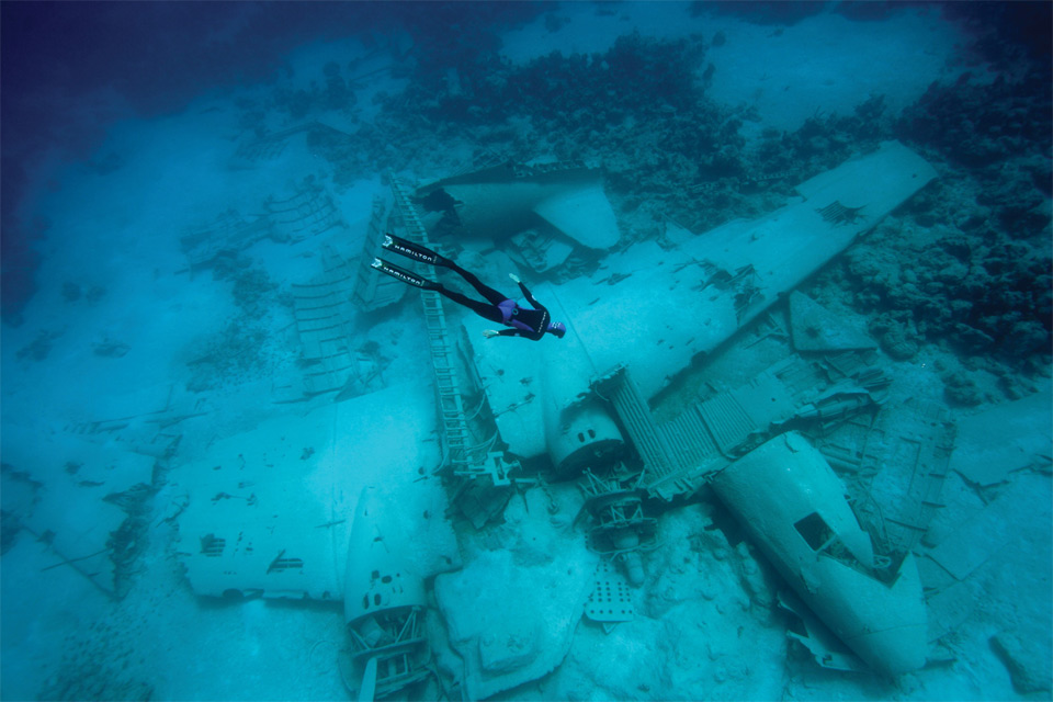 freediver over the airplane wreck in the bahamas
