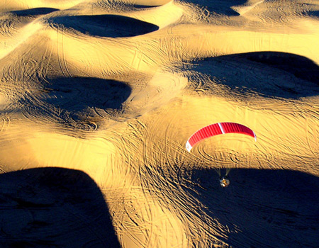 paragliding over dunes