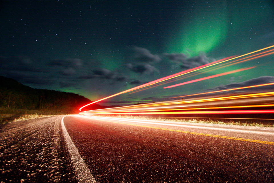 northern lights over roads of alaska