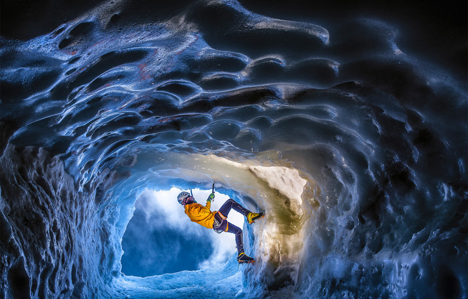climbing in a glacial ice cave in the alps