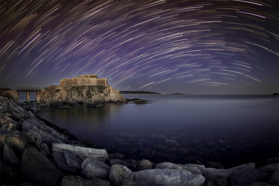 star trails over fort at la tour fondue, southern france