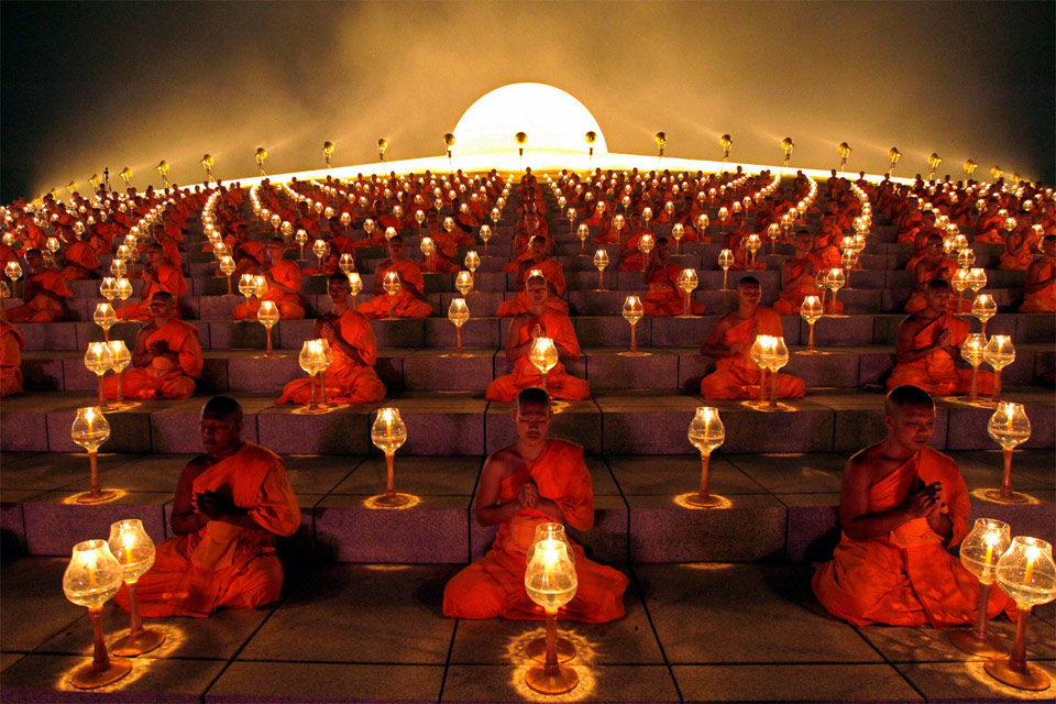 buddhist monks at a lantern lighting ceremony