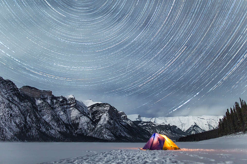 star trails above rocky mountains