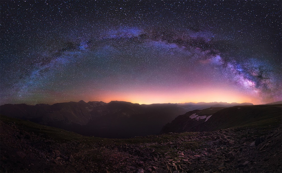 milky way above rocky mountains