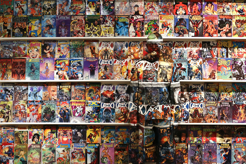 artist blends himself into comic book shelf