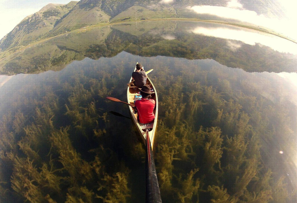 canoeing in a crystal clear lake, italy