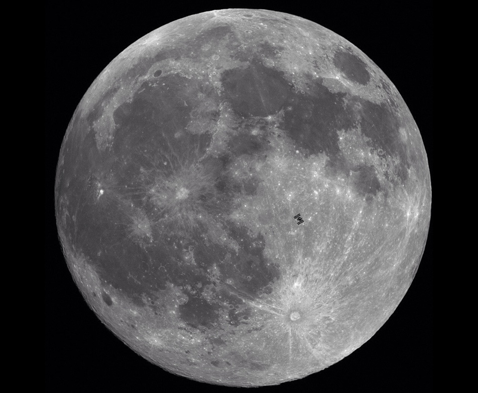 international space station passing the moon