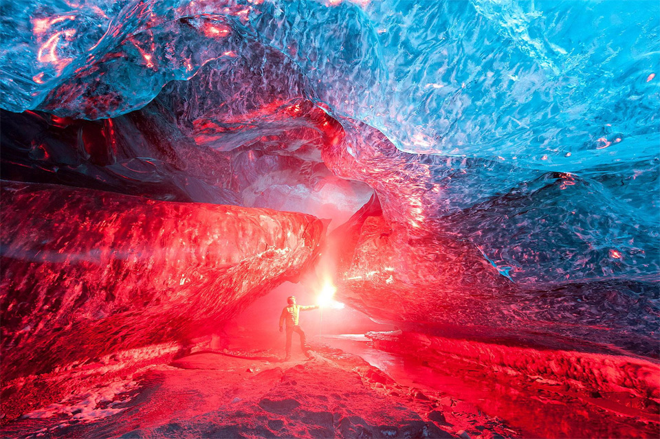 lighting a flare inside iceland ice cave
