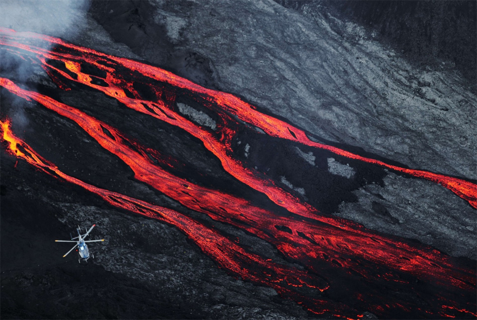 Helicopter Flies Over Lava Flows