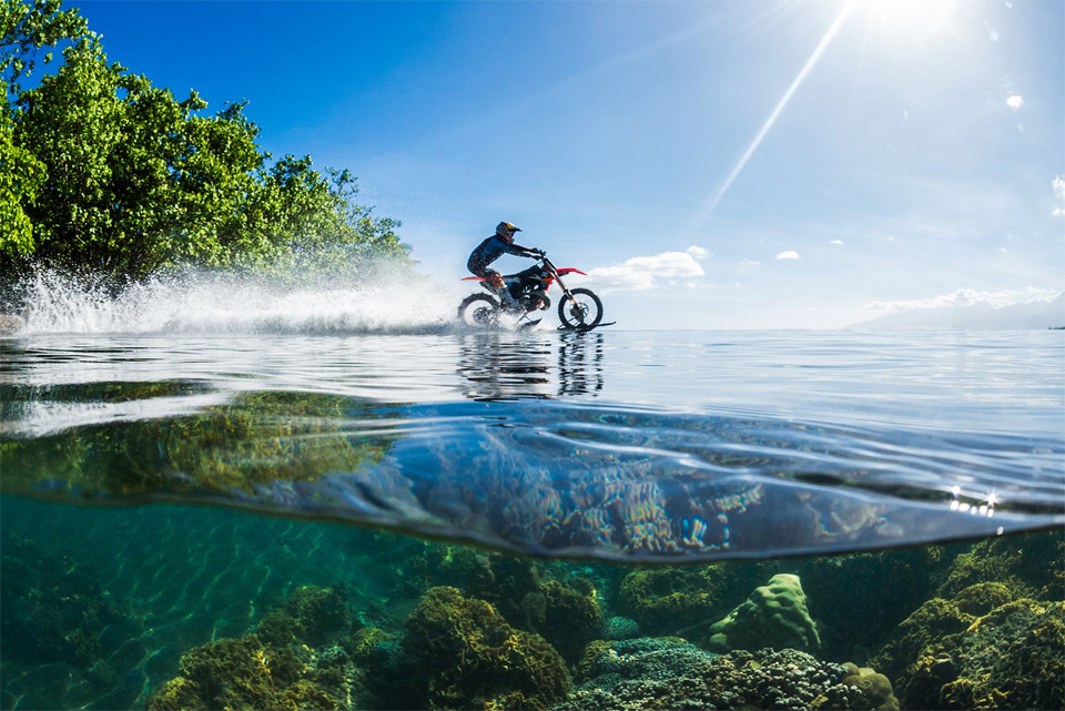 Riding Dirt Bike On Clear Waters Of Tahiti