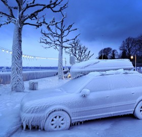ice covered car by the frozen lake geneva