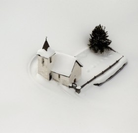 church in switzerland surrounded by snow