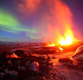 erupting volcano with northern light, iceland