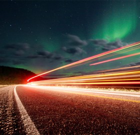 northern lights over roads of alaska