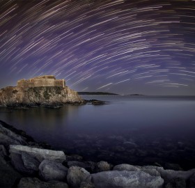 star trails over fort at la tour fondue, southern france