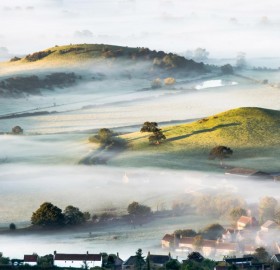 mist over countryside, england