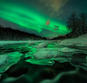 aurora shines over river, norway