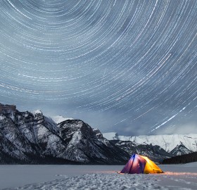 star trails above rocky mountains