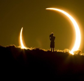 person framed by the annular solar eclipse