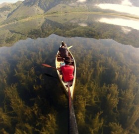 canoeing in a crystal clear lake, italy