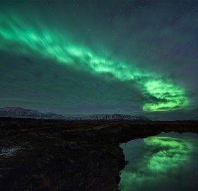 aurora borealis behind clouds
