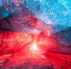 lighting a flare inside iceland ice cave