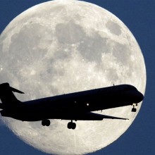 moon behind airplane