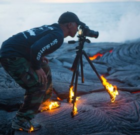 photographer without limits. taking a photo on lava
