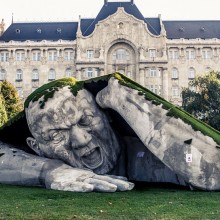 gigantic man crawls out from the earth sculpture, budapest