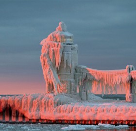 frozen lighthouse on lake michigan