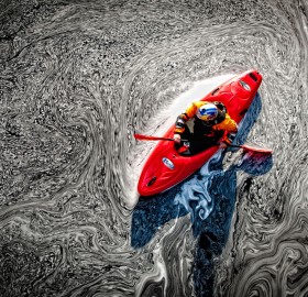 kayaker in a pool of mesmerizing foam