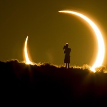 person framed by the annular solar eclipse