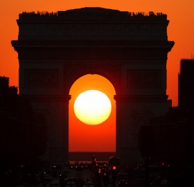 sunset in the middle of arc de triomphe, paris