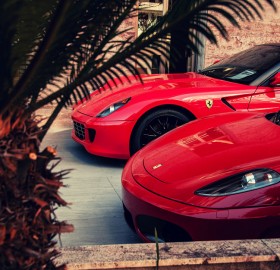 two red parked ferrari`s
