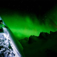 skiing under aurora borealis