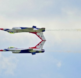 two planes flying at high speed performing a mirror image