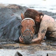 Staying By Horse Side After Getting Trapped in Mud