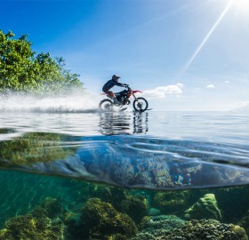Riding Dirt Bike On Clear Waters Of Tahiti