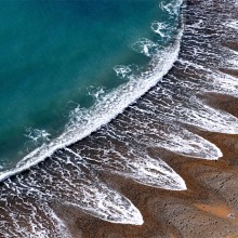 Waves Creates A Pattern On A Beach In Dorset, England