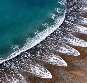 Waves Creates A Pattern On A Beach In Dorset, England